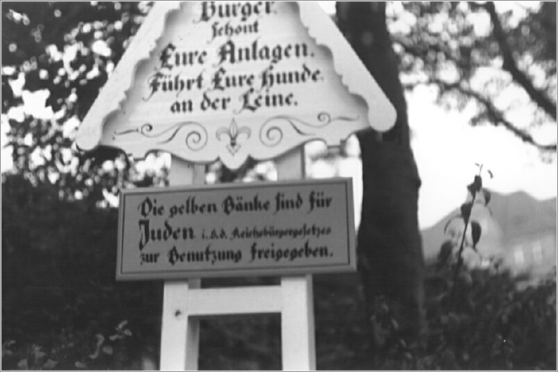 Sign in a Berlin park reads -The yellow benches are for Jews